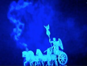 A.P. ASTRA - Cross: A blue-tinted image of a statue featuring a winged figure riding a chariot pulled by four horses, with swirling mist or smoke in the background.