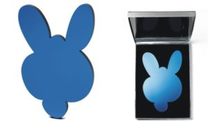 A blue mirror shaped like a rabbit’s head is shown alone and also inside an open compact case with a reflective interior, reminiscent of JEFF KOONS - Mirror Box (Kangaroo).