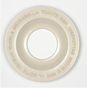 A white, round plate with a wide rim and a hollow center. Inspired by Martin Kippenberger - Italienischer Teller (italian plate), Italian words like "MOZZARELLA," "TOMATE," and "SPAGHETTI" are embossed around the rim.